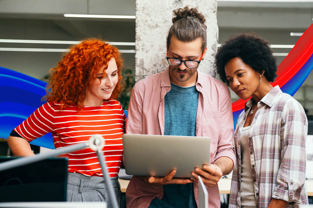 three people looking at laptop