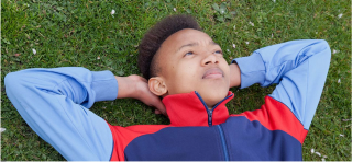 Child lying on the grass