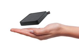 Streaming TV box floating above a hand